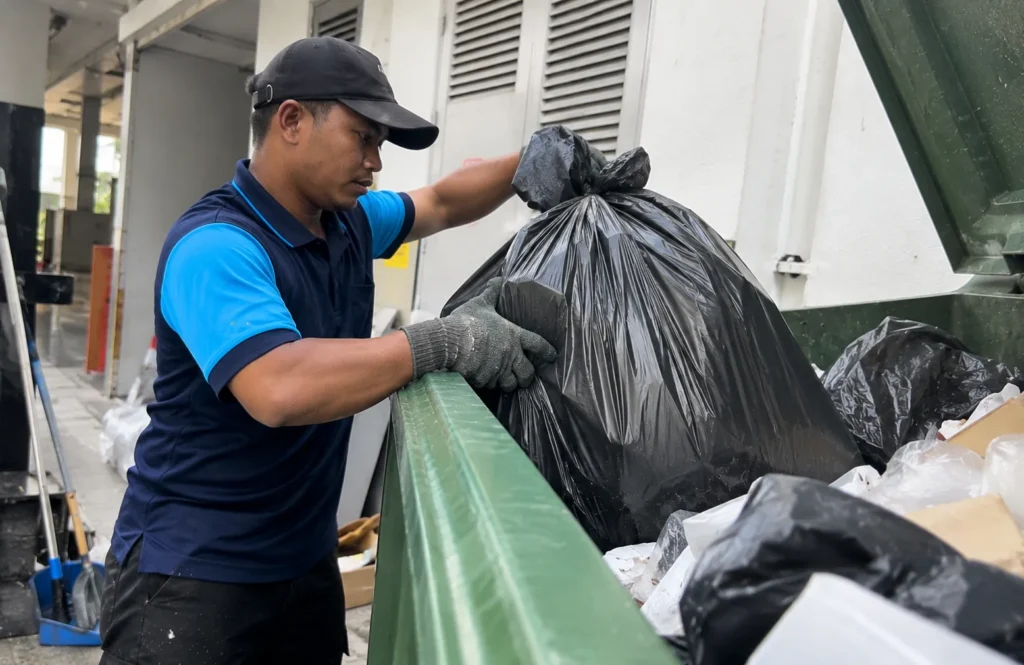 Worker handling waste bags for disposal - Waste Disposal in Setapak